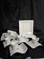 Group of porcelain cups, saucers, plates, platter and divided dish