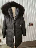 Full front view of black puffer coat on mannequin