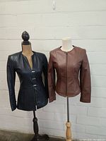 Both Danier leather jackets displayed on mannequins