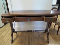Full view of wood console table, drawers open