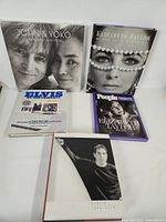 Front covers of all five books displayed upright