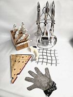 Overall view of knife block, knives, utensil carousel, cheese board, grid and glove