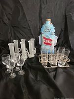 Group shot of decanter, shooters, wine glasses, tumblers in carrier