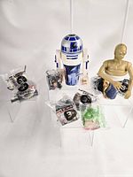 Full lot view with two large cup toppers and seven sealed toys