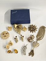 All 13 jewellery pieces laid out with Harrods box