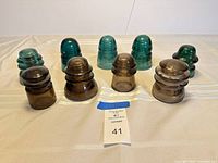 Group shot of all nine glass insulators showing color variety and overall condition