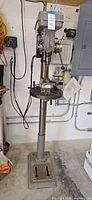 Full view of Buffalo FDM-5 floor drill press on pedestal base with mounted vise