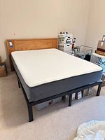 Overall view of mattress on frame with headboard