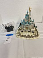 Front view of castle figurine with AC adapter bag visible