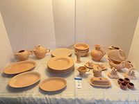 Full lot showing all Fiesta peach ceramic pieces