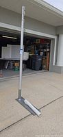 Flagpole assembled in surface mount showing height and accessories at base