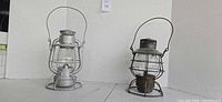 Two vintage railroad lanterns side by side