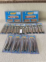 Full lot view showing two boxed train sets and fourteen track packs