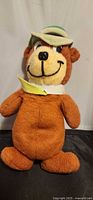 Full view of Yogi Bear plush doll standing upright
