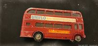 Right side view showing UNIFLO advert, London Transport panel, missing wheel, paint wear