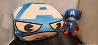 Front view of Miniso Captain America pillow beside mini plush figure
