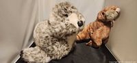 Seal and walrus plush toys together in corner