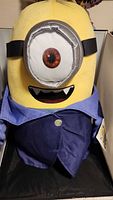 Full front view of large Minion plush with jacket