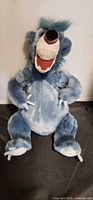 Front view of blue-grey Baloo plush sitting upright