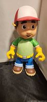 Full front view of Handy Manny plastic talking doll
