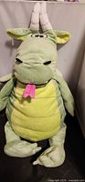 Front view of green dragon plush showing full body