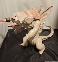 Side view of Wilderbeast action figure standing, showing full body and tail