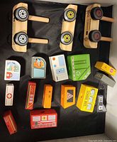 Two wooden wheeled bases with pegs and assorted printed blocks displayed