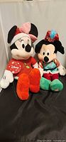 Both Disney plush toys side by side
