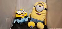 Two Minion plush toys side by side