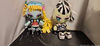 Both Monster High plush dolls side by side