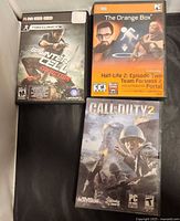 Front view of three boxed PC games