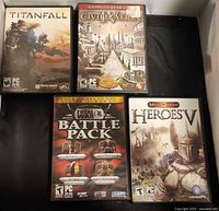 Front view of four PC game cases: Titanfall, Civilization IV GOTY, Total War Battle Pack, Might & Magic Heroes V