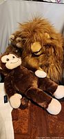 Group shot of three plush toys: large shaggy orangutan, Build-A-Bear monkey, small Jimby plush