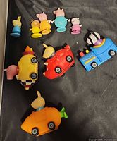 All nine toys laid out: five figures, four vehicles