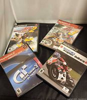 Front covers of four PS2 racing games