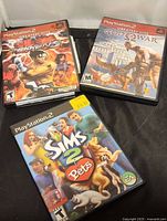 Front view of three PS2 game cases