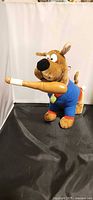 Front view of Scooby-Doo plush holding baseball bat