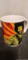 Front view of mug showing main Hendrix portrait and vibrant colour scheme