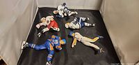 Group of five loose McFarlane sports figures on black backdrop