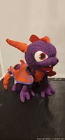 Front view of purple Spyro plush with orange accents