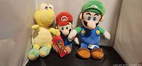 Front view of three plush toys: Koopa Troopa, Mario, Luigi
