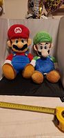 Mario and Luigi plush dolls side by side