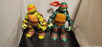 Both TMNT figures standing side by side