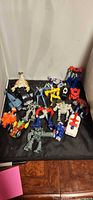 Group shot of entire lot of Transformers kids meal toys on black backdrop