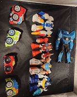 Nine Rescue Bots items laid out showing both robot and vehicle forms