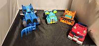 All four Rescue Bots figures displayed in vehicle mode