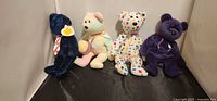 All four Ty Beanie Baby bears upright against wall