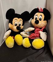 Front view of Mickey and Minnie plush dolls seated