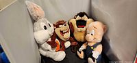 Group shot showing all four Looney Tunes plush toys