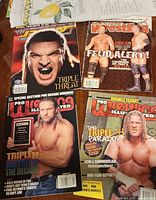 Four magazines laid out showing all covers and key-tag nearby